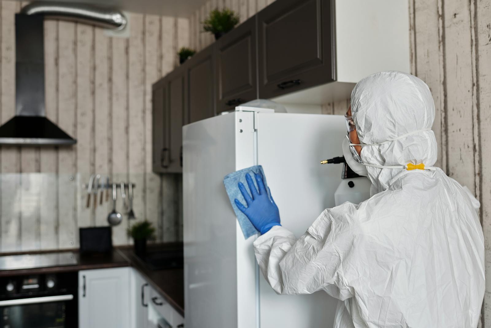 Protective worker holding disinfection equipment